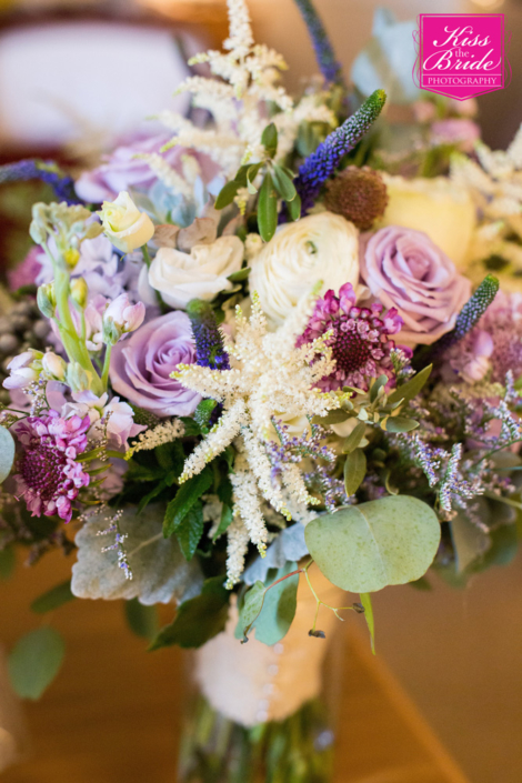 A bouquet of purple and white flowers sits on a table.