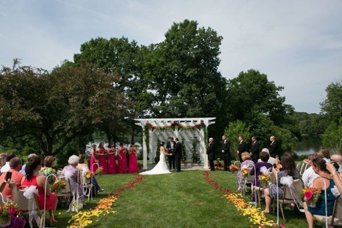 A wedding ceremony on a grassy lawn.
