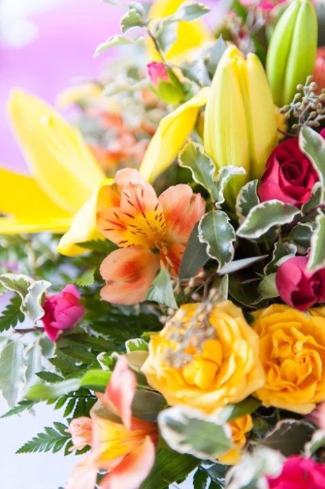 A bouquet of brightly colored flowers in a vase.