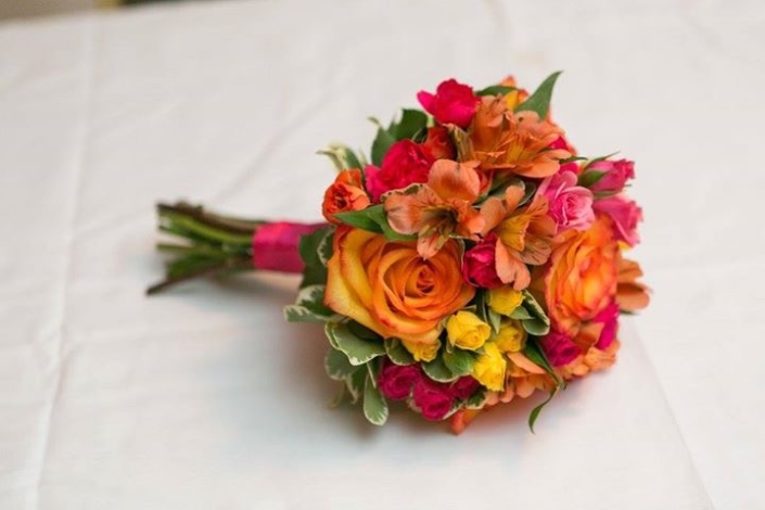 A bouquet of brightly colored flowers on a table.