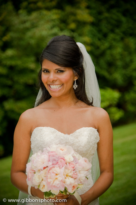 A bride holding a bouquet of pink and white flowers.