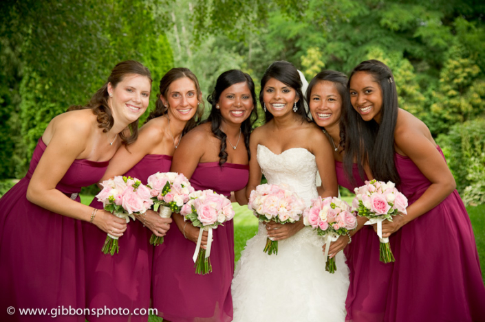 A group of bridesmaids posing with their bouquets.