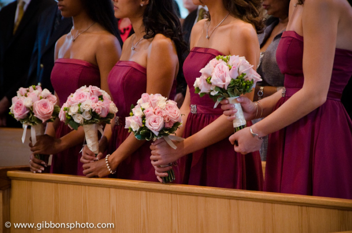 The bridesmaids are holding pink bouquets.