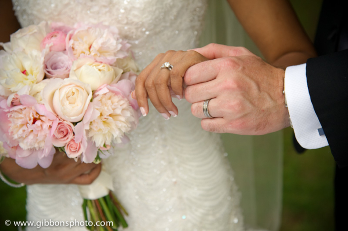 A bride and groom holding hands.