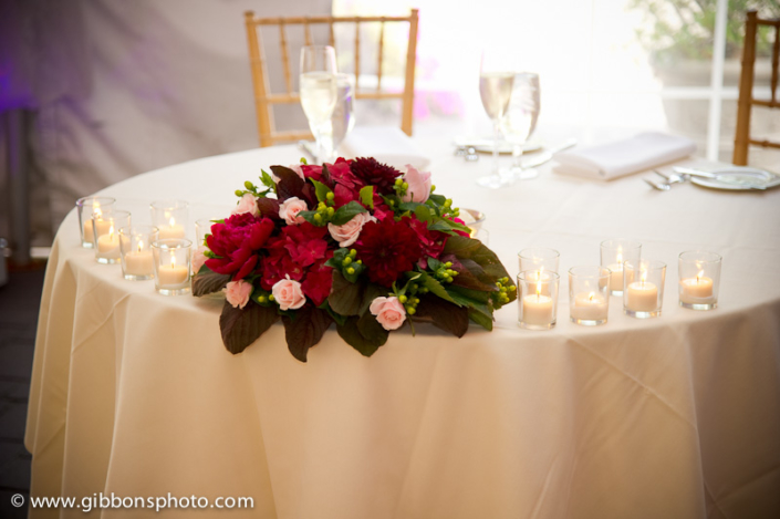 A table with flowers and candles on it.