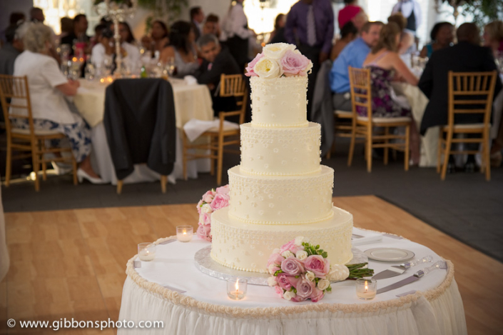 A wedding cake sits on top of a table.