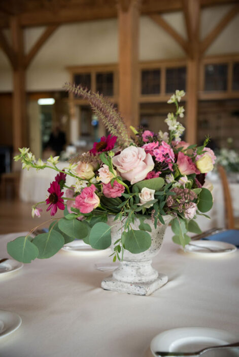 An arrangement of pink and green flowers on a table.