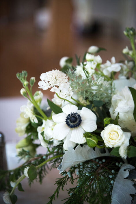 White flowers in a vase on a table.