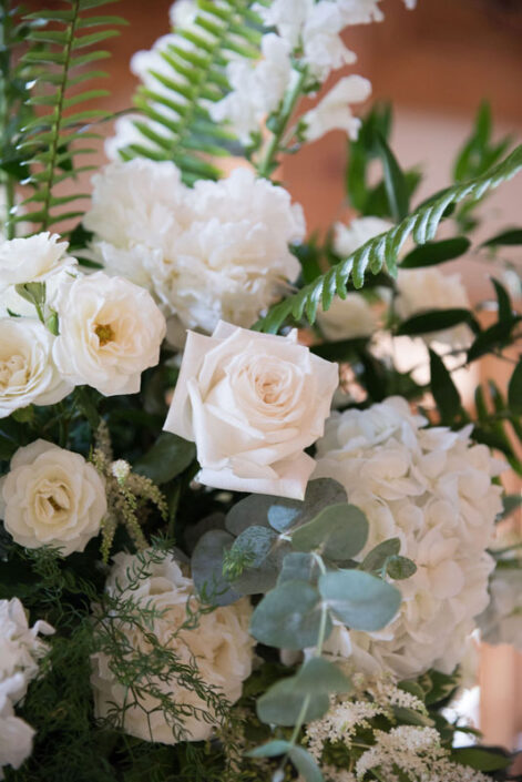 White roses and eucalyptus in a vase.