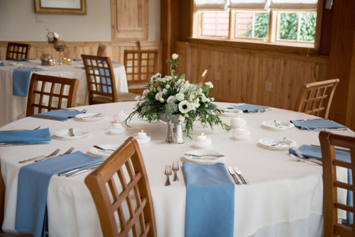 A table setting with blue and white place settings.
