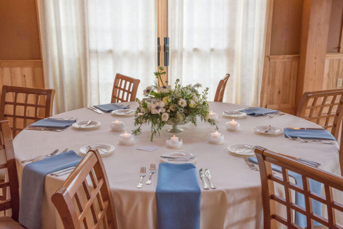 A table setting with blue and white napkins.