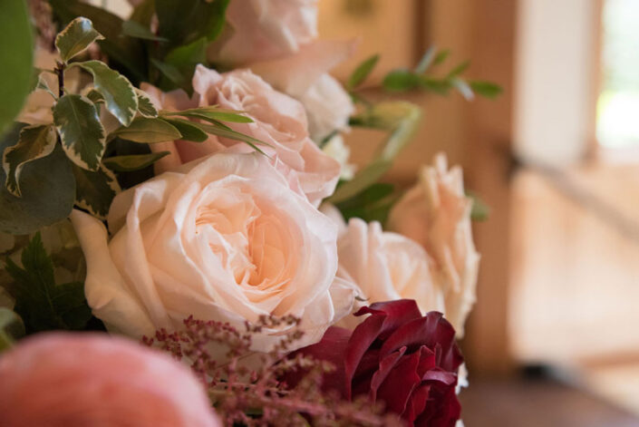 A close up of a bouquet of pink and red roses.