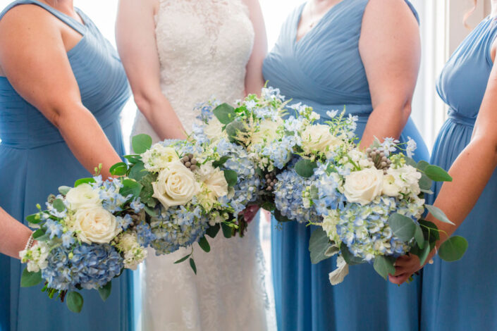 Bridesmaids in Blue Dresses and White Flowers