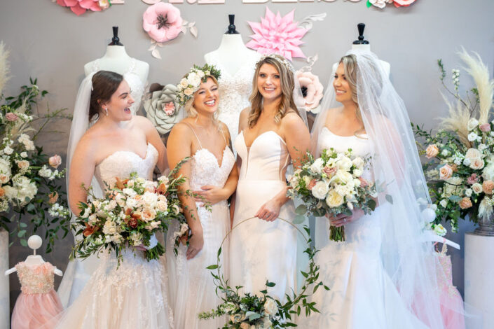 group photo bridesmaid with brides and flowers
