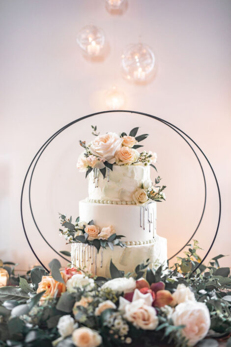A wedding cake is sitting on top of a table.