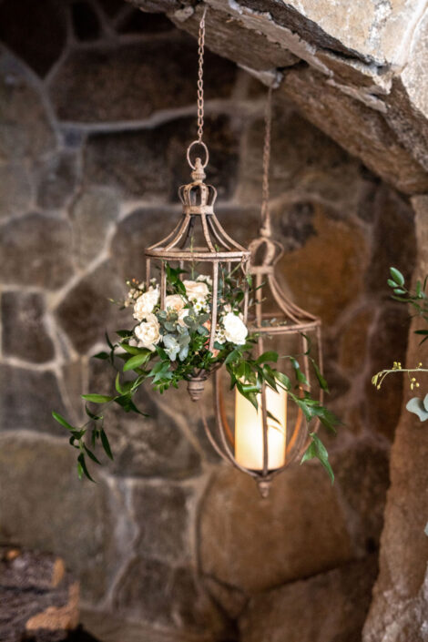 Two lanterns hanging from a stone wall.