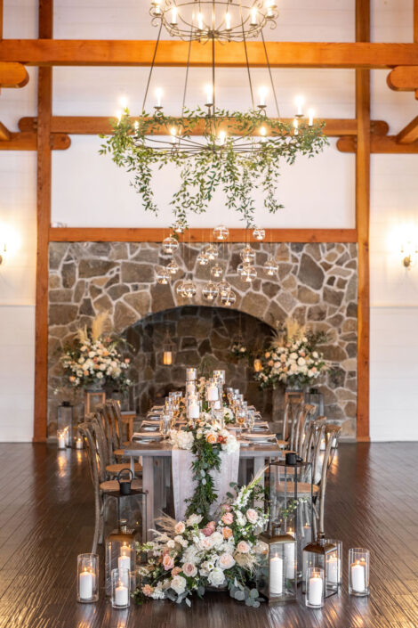 A rustic barn wedding with candles and greenery.