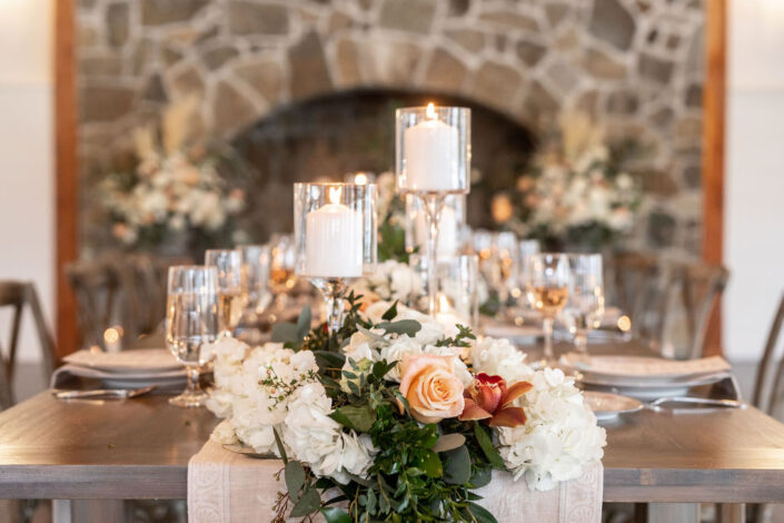 A table setting with candles and flowers.