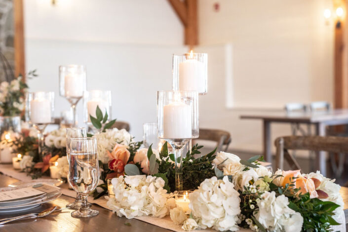 A long table with candles and flowers.