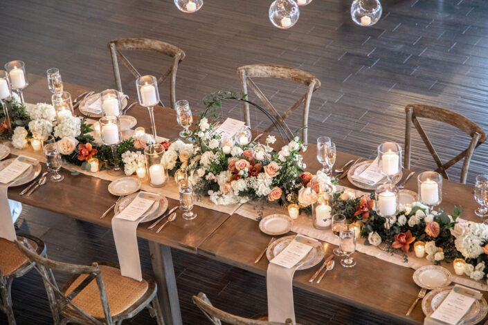 A table set up with candles and flowers.