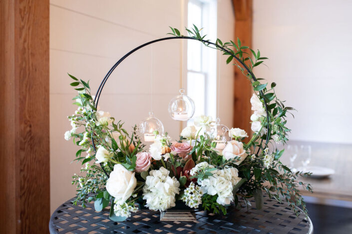 An arrangement of flowers and greenery on a table.