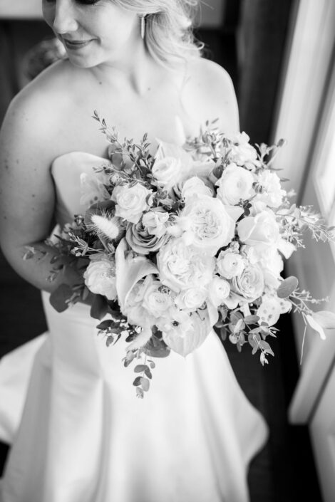 A black and white photo of a bride holding a bouquet.