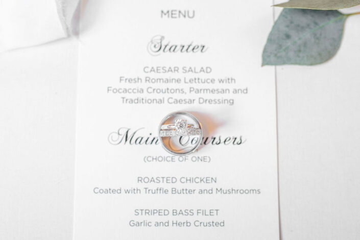 A wedding menu with a wedding ring on it.