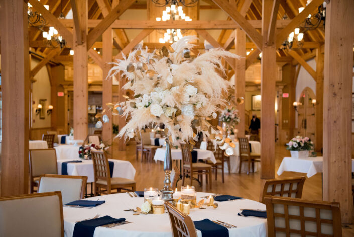 A wedding reception set up in a large room with wooden beams.