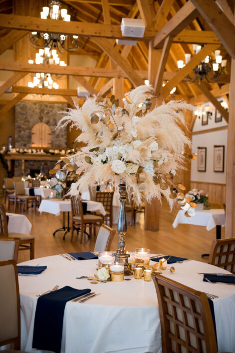 A wedding reception with a large centerpiece of feathers.
