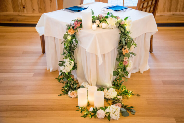 A wedding table decorated with flowers and candles.