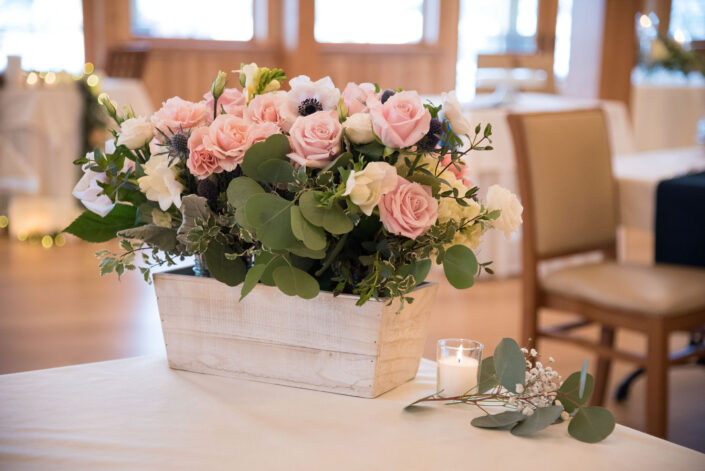 An arrangement of pink and white flowers on a table.