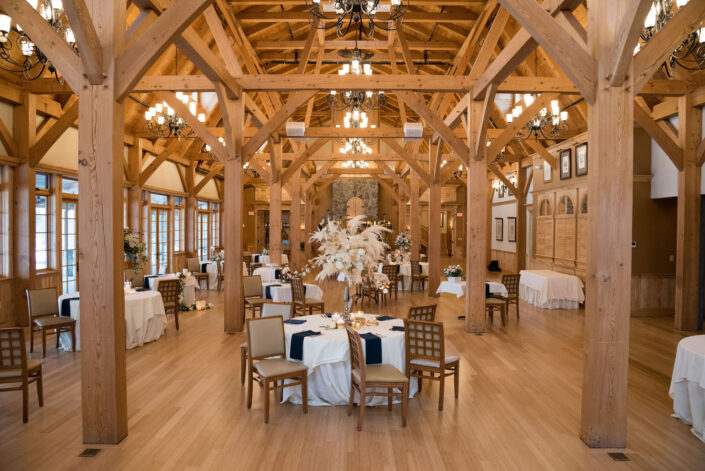 A large room with wooden beams and tables.