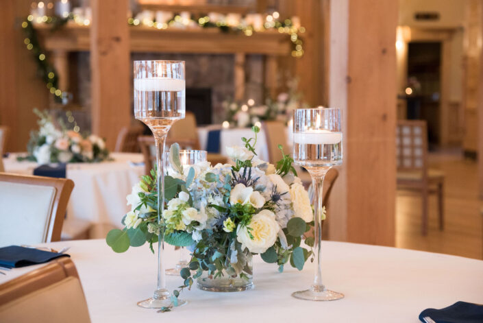 A table with candles and flowers at a wedding reception.