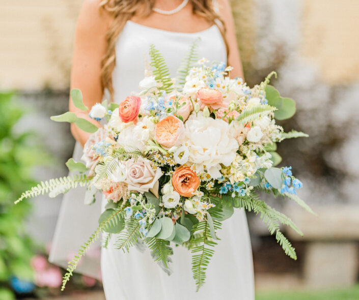A bride in a white dress holding a bouquet.