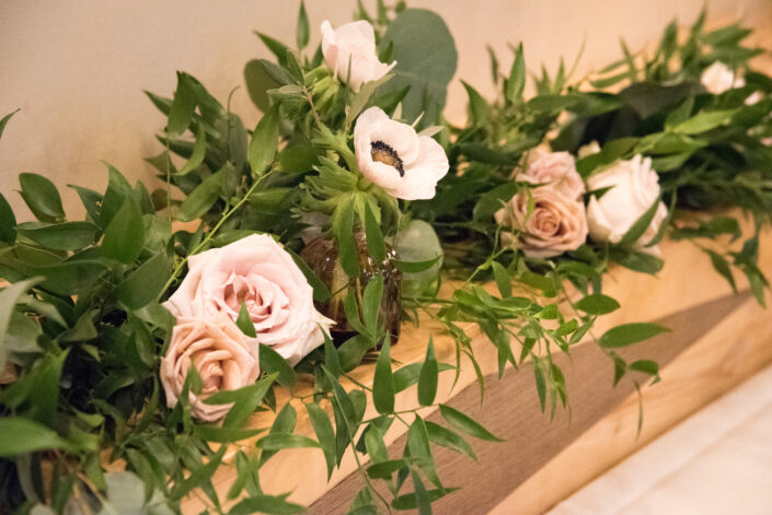 closeup shot of roses and other flowers with leaves