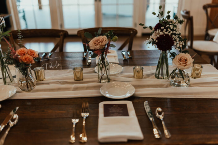A table setting with flowers and silverware.