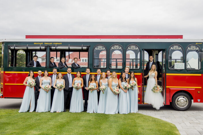 bridesmaid and groomsmen near a bus