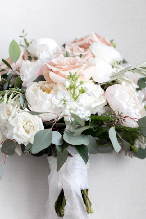 A bouquet of white and pink flowers with eucalyptus and eucalyptus.
