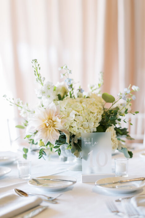 A table setting with white flowers and silverware.