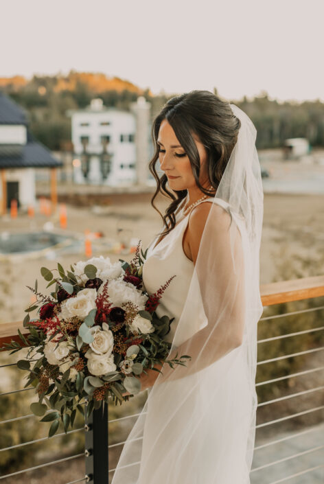 bride holding bouquet of flowers posing outdoors
